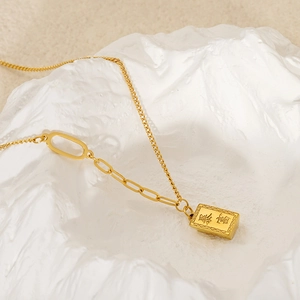 Gold stainless steel necklace with asymmetric chain and rectangular pendant engraved Bao Fu