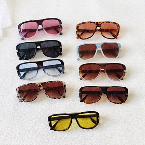 Flat lay of retro oval sunglasses in nine colors including tortoiseshell and blue gradient