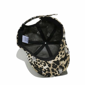 Detail view of the leopard print baseball cap interior featuring cotton wash label and stitching