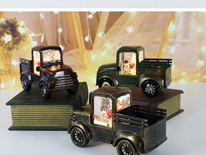Close-up of retro Christmas pickup truck water lanterns with Santa on vintage books