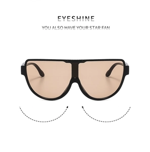 Detail view of stylish oversized black frame sunglasses with brown gradient lenses