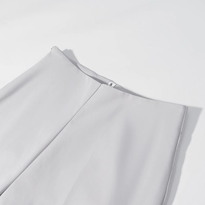 Detailed view of the waist area on gray suit trousers featuring an internal size S label