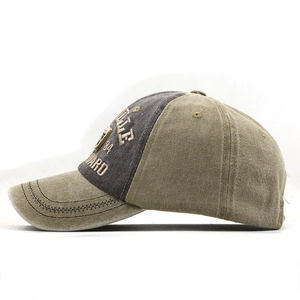 Close-up of vintage washed baseball cap featuring 3D embroidery and decorative metal plate