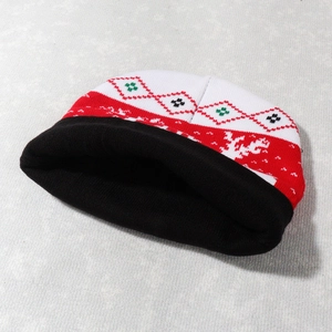 Detailed view of Christmas knit beanie with red and white snowflake and diamond patterns