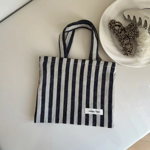 Detailed shot of black and white striped canvas tote with simple wish fabric label