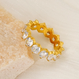 Detailed view of an 18k gold eternity ring with round cubic zirconia on stone decor