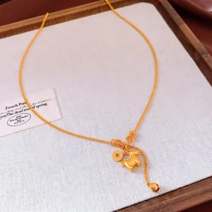 Gold-plated necklace featuring zodiac horse and coin pendants with delicate chain tassels