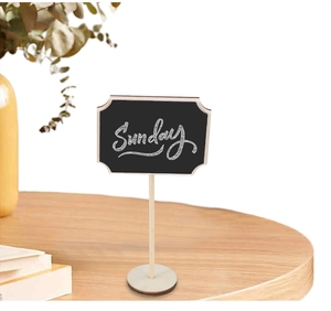 Macro detail of wave-edge wooden mini blackboard sign with Sunday script and round base