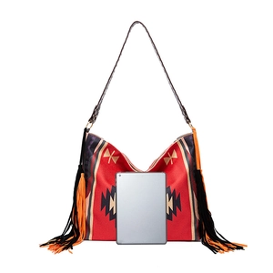 Detail of bohemian tote bag showing large capacity for tablet and colorful side tassels