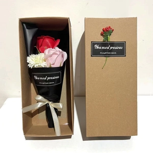 Macro detail of soap flower gift box with roses and carnations in kraft paper packaging