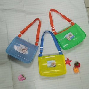 Three colorful mesh beach bags for kids in blue, green, and yellow with adjustable straps