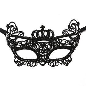 Close-up of black lace masquerade mask with intricate embroidery and crown design