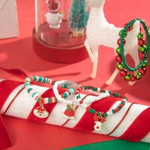 Detailed view of Christmas red cord beaded bracelet with Santa and Reindeer charms