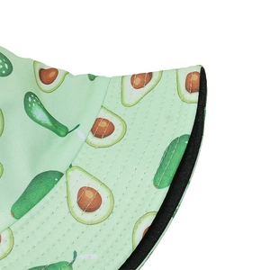 Close-up of light green bucket hat featuring cartoon avocado print and reinforced stitching