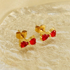 Bow-knot stud earrings with gold plating and red heart-shaped crystals on glass