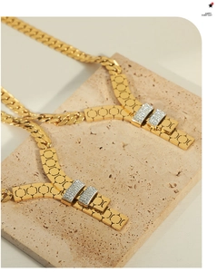 Macro view of gold-plated rectangular links with honeycomb texture and zircon pave setting