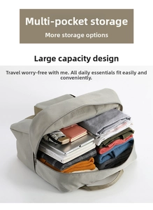 Top view of large gray travel bag interior filled with clothes, books, and essentials