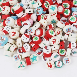 Macro view of Christmas polymer clay beads featuring Santa, trees, and snowflake patterns