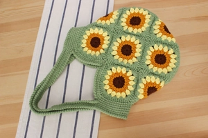 Detailed close-up of handmade sunflower crochet tote bag showing thick wool texture