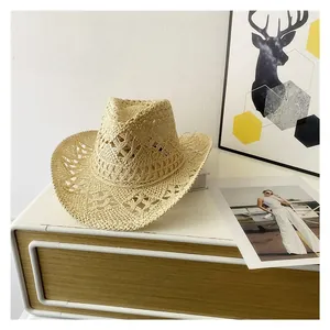 Close-up of woven beige straw cowboy hat featuring hollow knit texture on wooden surface