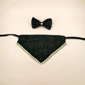 Detail of black tweed pet bib with pearl accents and a matching bow tie set
