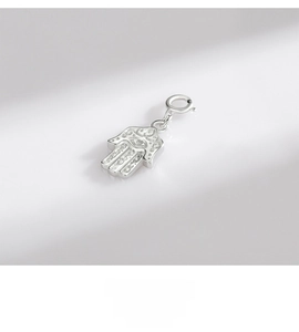 Macro shot of S925 sterling silver Hamsa Hand pendant with detailed totem engraving