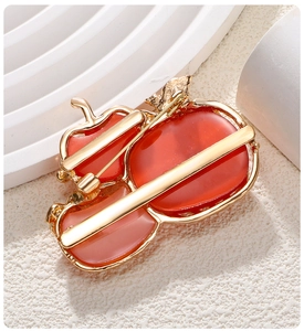 Detailed back view of persimmon brooch with golden alloy pin and secure clasp