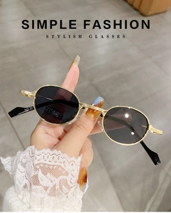 Detail of gold metal temples with model number engraving on oval retro sunglasses