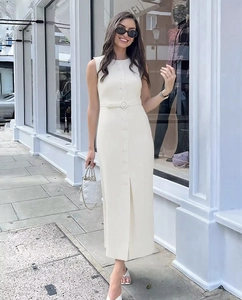 Detail of elegant cream sleeveless midi dress with front buttons and circular buckle belt