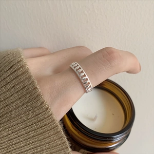 S925 sterling silver hollow geometric olive leaf ring on finger with warm cozy aesthetic