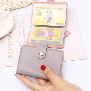 Detail of lychee leather card holders in grey-purple and pink with snap button closure