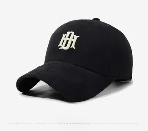 Detail view of the high-quality 3D white embroidered HI logo on a black cotton baseball cap