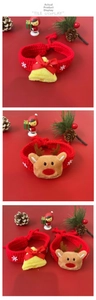 Detail of red knitted Christmas pet collar with handmade reindeer and bell ornaments