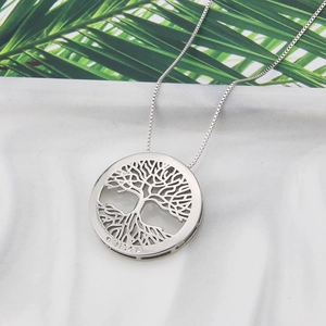 Minimalist silver life tree necklace with VIDA engraving on round hollow pendant