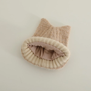 Detailed macro view of the double-layered plush knit fabric and cat ear design of the hat