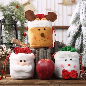 Detailed close-up of velvet Christmas drawstring bags featuring reindeer and Santa designs