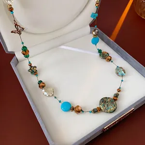 Bohemian multilayer beaded necklace with turquoise beads and bronze flower charms