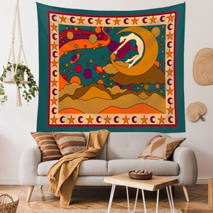 Bohemian wall tapestry featuring a woman on a crescent moon above desert hills