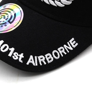 Close-up of 101st Airborne embroidery and laser anti-counterfeit label on a black tactical cap