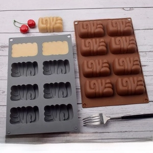Detailed top view of 8-cavity silicone mold with LOVE letter shapes for DIY baking