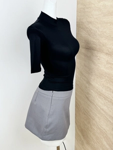 Side view of slim fit black mock neck T-shirt with short sleeves on a white mannequin
