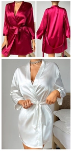 Detail of silk satin robes in burgundy and white with tie waist and elegant fringe trim