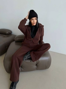 Detail of coffee brown hooded sweatshirt and matching wide-leg pants fabric texture