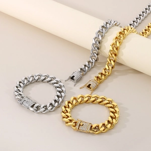 Macro detail of gold and silver Cuban link chains with CNC encrusted rhinestones on clasps