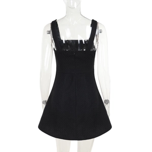Detailed back view of a black tweed-textured dress with invisible zipper and wide straps