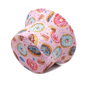 Pink bucket hat with colorful donut and candy prints for casual outdoor sun protection