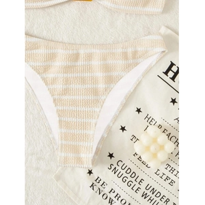 Detailed view of beige striped seersucker bikini bottoms with textured fabric finish