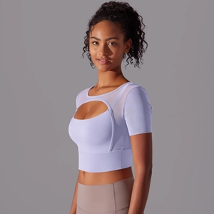 Detail of lavender mesh patchwork crop top with crescent cutout for yoga and fitness