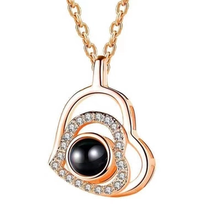 Rose gold heart projection necklace with a black stone inlay and sparkling zircon crystals