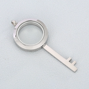 Macro view of silver stainless steel key locket pendant with transparent glass frame